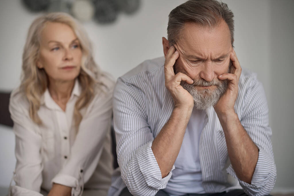 Senior Gray couple looking unhappy