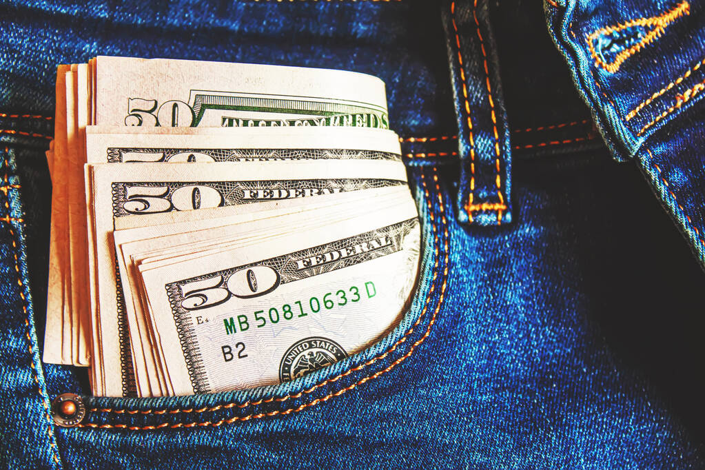 Money sticking out of jeans pocket