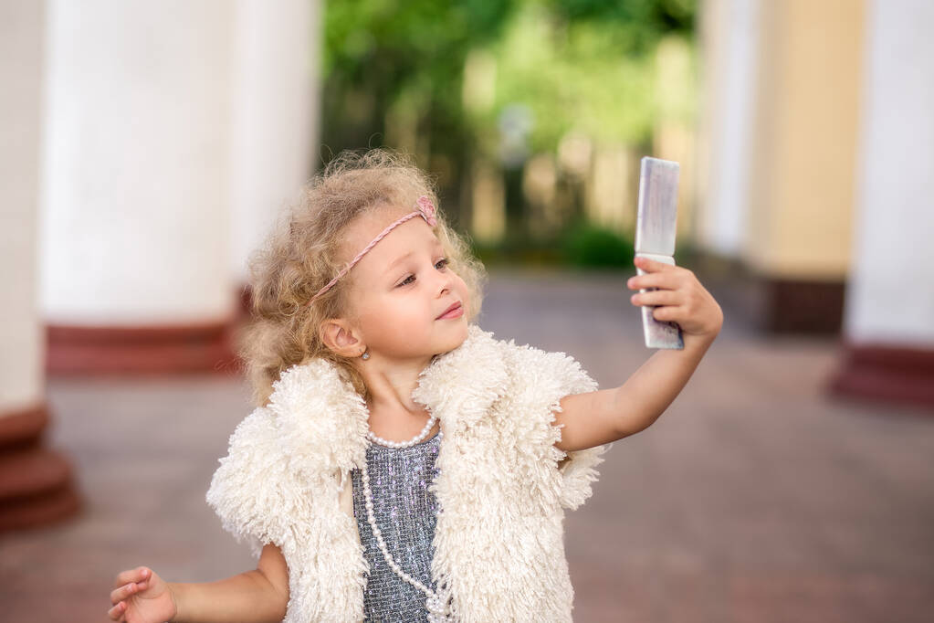 Narcissistic little Girl Admiring herself while taking selfie on phone